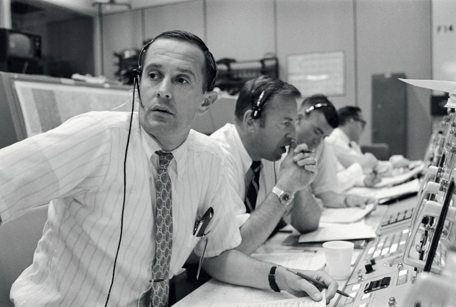 Salle de contrôle de Houston pendant l'alunissage d'Apollo 11 : les communicateurs de vol Charles Duke, James Lovell et Fred Haise à la console Capcom, le 20 juillet 1969.
